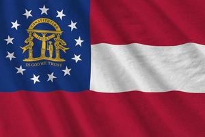 Georgia US state flag with big folds waving close up under the studio light indoors. The official symbols and colors in banner photo