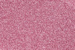 Pink decorative sequins. Background image with shiny bokeh lights from small elements Image toned in Viva Magenta, color of the 2023 year photo