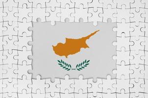 Cyprus flag in frame of white puzzle pieces with missing central part photo