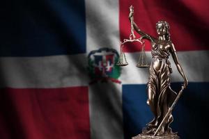 Dominican Republic flag with statue of lady justice and judicial scales in dark room. Concept of judgement and punishment photo