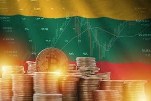 Lithuania flag and big amount of golden bitcoin coins and trading platform chart. Crypto currency photo
