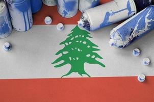 Lebanon flag and few used aerosol spray cans for graffiti painting. Street art culture concept photo