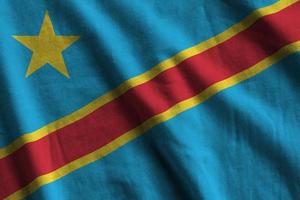 Democratic Republic of the Congo flag with big folds waving close up under the studio light indoors. The official symbols and colors in banner photo