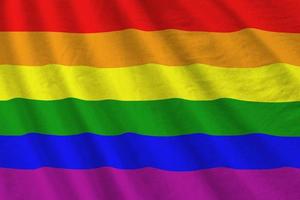 LGBT community flag with big folds waving close up under the studio light indoors. The official symbols and colors in banner photo