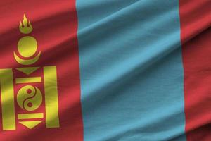 Mongolia flag with big folds waving close up under the studio light indoors. The official symbols and colors in banner photo