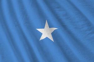 Somalia flag with big folds waving close up under the studio light indoors. The official symbols and colors in banner photo