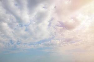 Blue sky background with white fluffy clouds in daytime outdoors photo