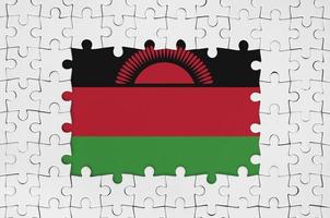 Malawi flag in frame of white puzzle pieces with missing central part photo