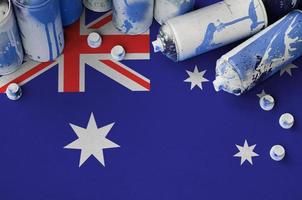 Australia flag and few used aerosol spray cans for graffiti painting. Street art culture concept photo