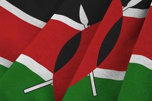 Kenya flag with big folds waving close up under the studio light indoors. The official symbols and colors in banner photo