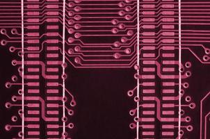 Close up of ed micro circuit board. Abstract technology background. Image toned in Viva Magenta, color of the 2023 year photo