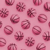 Many small orange balls for basketball sport game lies on texture background of fashion pastel orange color paper in minimal concept Image toned in Viva Magenta, color of the year photo