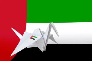 United Arab Emirates flag depicted on paper origami crane wing. Handmade arts concept photo