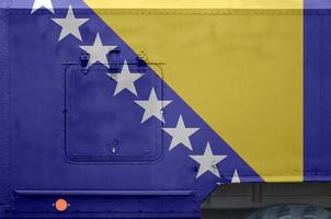 Bosnia and Herzegovina flag depicted on side part of military armored truck closeup. Army forces conceptual background photo