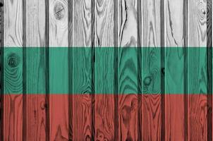 Bulgaria flag depicted in bright paint colors on old wooden wall. Textured banner on rough background photo