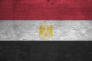 Egypt flag depicted in paint colors on old brick wall. Textured banner on big brick wall masonry background photo