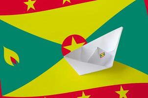 Grenada flag depicted on paper origami ship closeup. Handmade arts concept photo