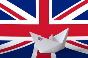 Great britain flag depicted on paper origami ship closeup. Handmade arts concept photo