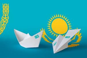 Kazakhstan flag depicted on paper origami airplane and boat. Handmade arts concept photo