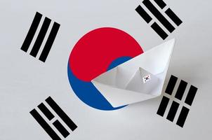 South Korea flag depicted on paper origami ship closeup. Handmade arts concept photo