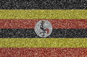 Uganda flag depicted on many small shiny sequins. Colorful festival background for party photo