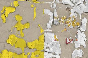 Vatican City State flag depicted in paint colors on old obsolete messy concrete wall closeup. Textured banner on rough background photo