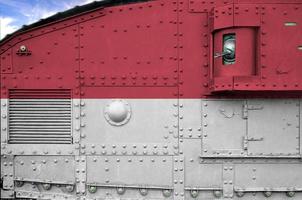 Indonesia flag depicted on side part of military armored tank closeup. Army forces conceptual background photo