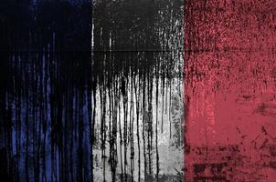 France flag depicted in paint colors on old and dirty oil barrel wall closeup. Textured banner on rough background photo