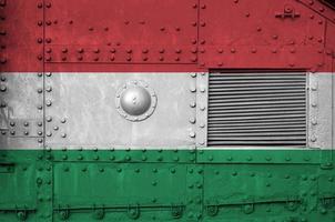 Hungary flag depicted on side part of military armored tank closeup. Army forces conceptual background photo