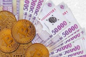 50000 Romanian leu bills and golden bitcoins. Cryptocurrency investment concept. Crypto mining or trading photo