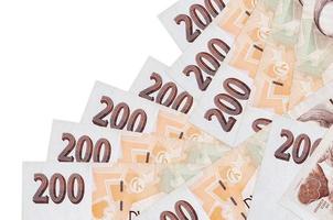 200 Czech korun bills lies in different order isolated on white. Local banking or money making concept photo