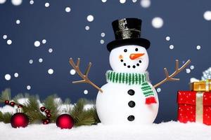 Funny snowman. Merry christmas and happy new year greeting card. Snowy background. photo