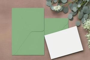 Mockup for a letter or wedding invitation with branches and leaves. Natural light and shade coverage. photo