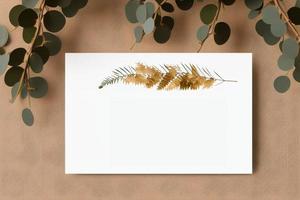 Mockup for a letter or wedding invitation with branches and leaves. Natural light and shade coverage. photo