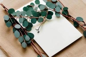 Mockup for a letter or wedding invitation with branches and leaves. Natural light and shade coverage. photo