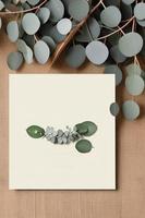 Mockup for a letter or wedding invitation with branches and leaves. Natural light and shade coverage. photo