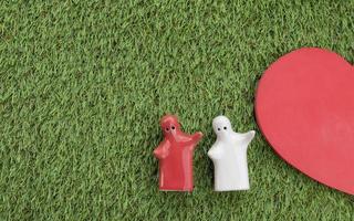 Top view mock up couple hugging on grass floor and mock up half heart with copy space. Valentine day concept photo