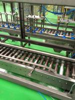 Conveyor belt of glass bottles into the drinking water filling process. photo