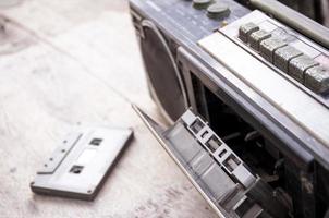 Retro radio and cassette tape on wood floor photo