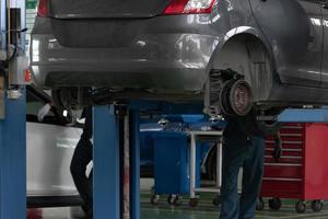 Car service - Mechanic changing wheel photo