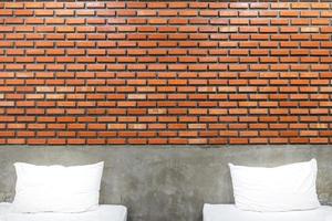 White pillows in a vintage and loft bedroom with brown brick wall vintage background photo