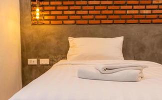 Close up White towels in the vintage and loft style bedrooms in the room decorate the walls with brown bricks. photo