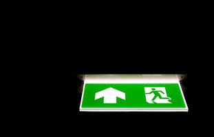 Green emergency exit sing in darkness photo