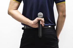 Man with a microphone in his back on white background photo