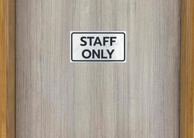 Warning sign in front of the door with a message for staff only photo