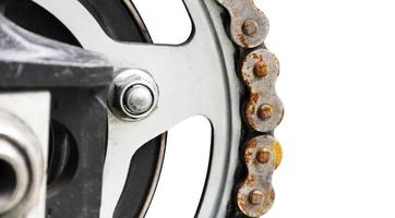 Motorcycle sprocket with texture rusty chain isolated on white background photo