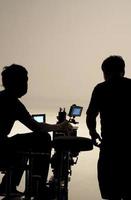 Behind the scenes of silhouette working people that making movie. photo