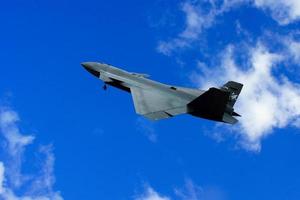 Bayraktar kizilelma nmanned fighter jet gliding through the white clouds. photo