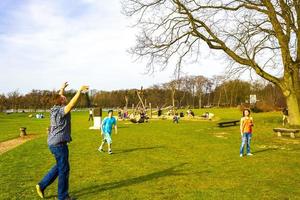 Bremerhaven Bremen Germany 2011 Teenagers play volleyball in park on grass in Germany. photo