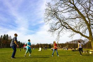 Bremerhaven Bremen Germany 2011 Teenagers play volleyball in park on grass in Germany. photo